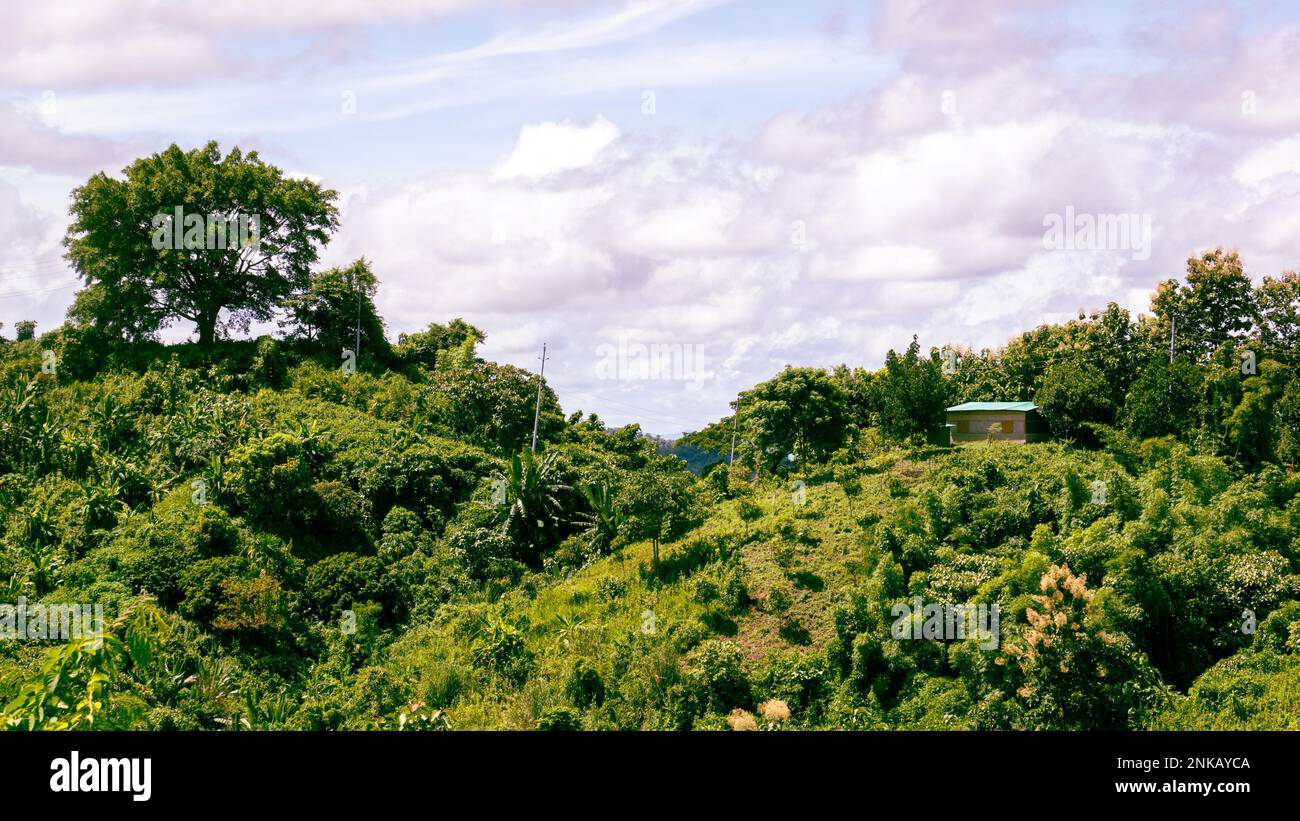 Aerial view of beautiful mountain landscape in the hills of Bandarban, Bangladesh. Zoom houses are visible in the distance. Photo taken from Meghla, B Stock Photo