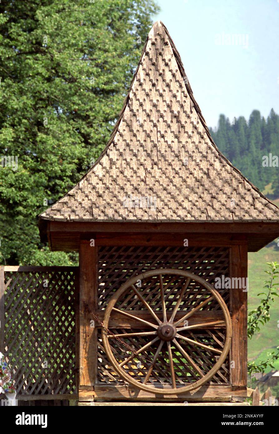 Straja, Suceava County, Romania, 1998. A beautiful water well with wheel and wooden outside structure. Stock Photo