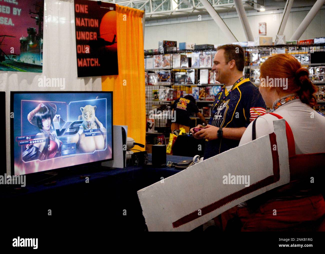The Navy esports team Goats and Glory members,  Lt. Aaron Jones from O'Fallon, Illinois and his teammate, Information Systems Technician 1st Class Rod Camiso from Worcester, Massachusetts, interact with guests at the Boston FanExpo Aug. 12-14, 2022.  The esports team members help answer questions on naval career and education opportunities through their online streaming platform. Stock Photo