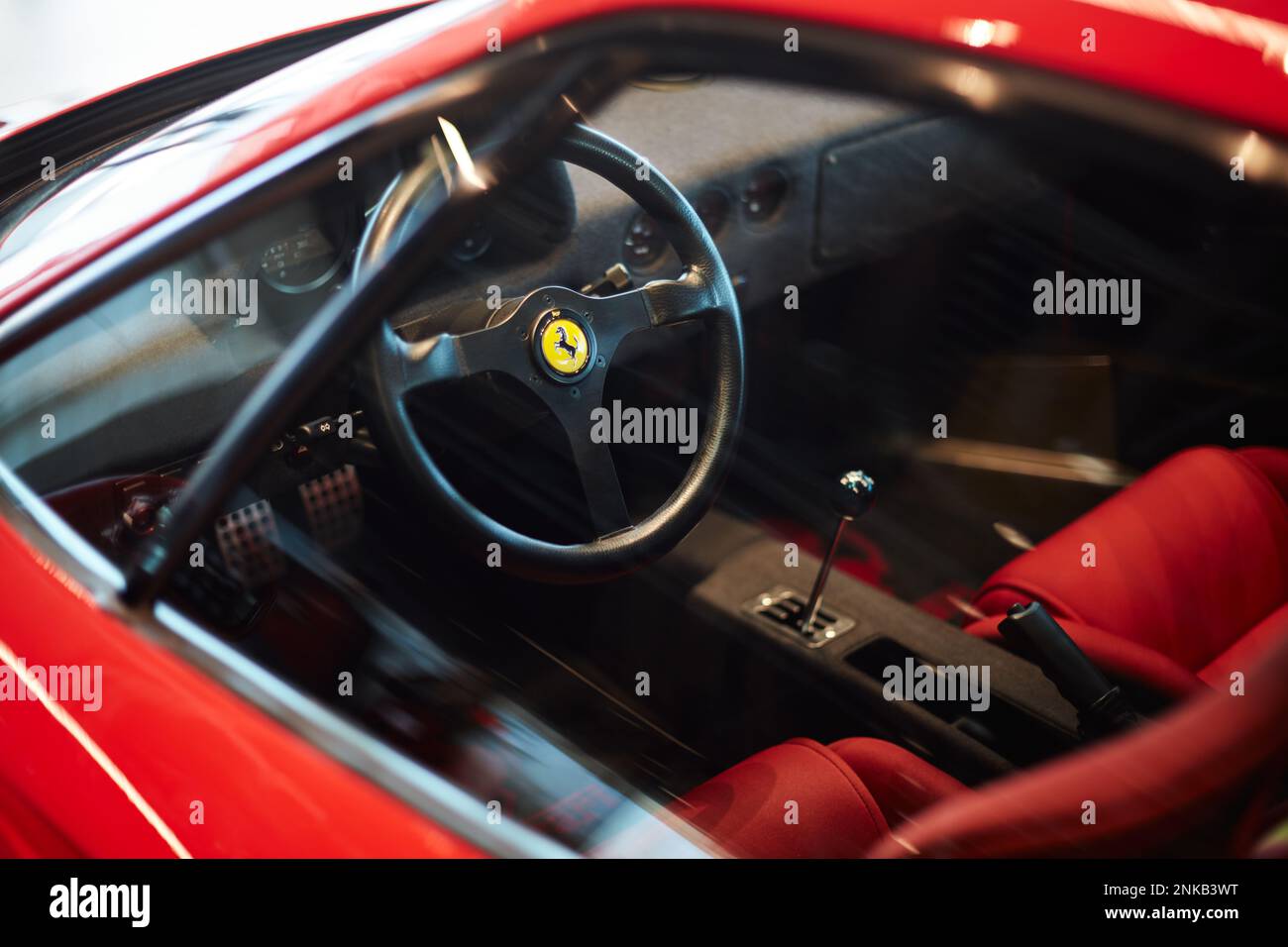 Ferrari F40 steering wheel, view through the driver's window. Small depth of field. Series of photos. Katowice, Poland - 03.23.2019 Stock Photo