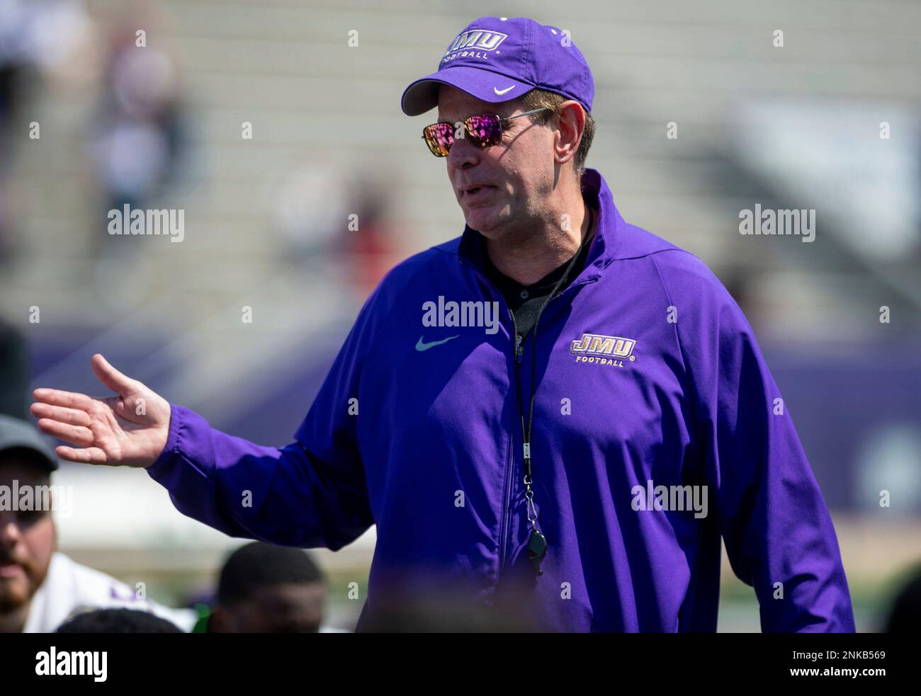 James Madison head coach Curt talks with his team after an
