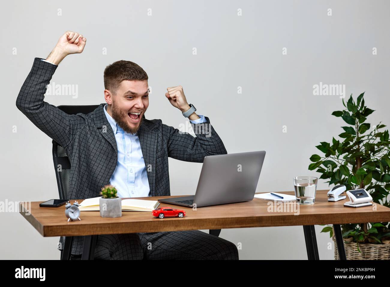 man sitting on chair at table and resting, using laptop Stock Photo