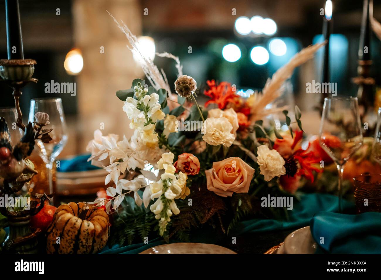 Exquisite, elegant golden and blue table set decoration in moody dark colors Stock Photo