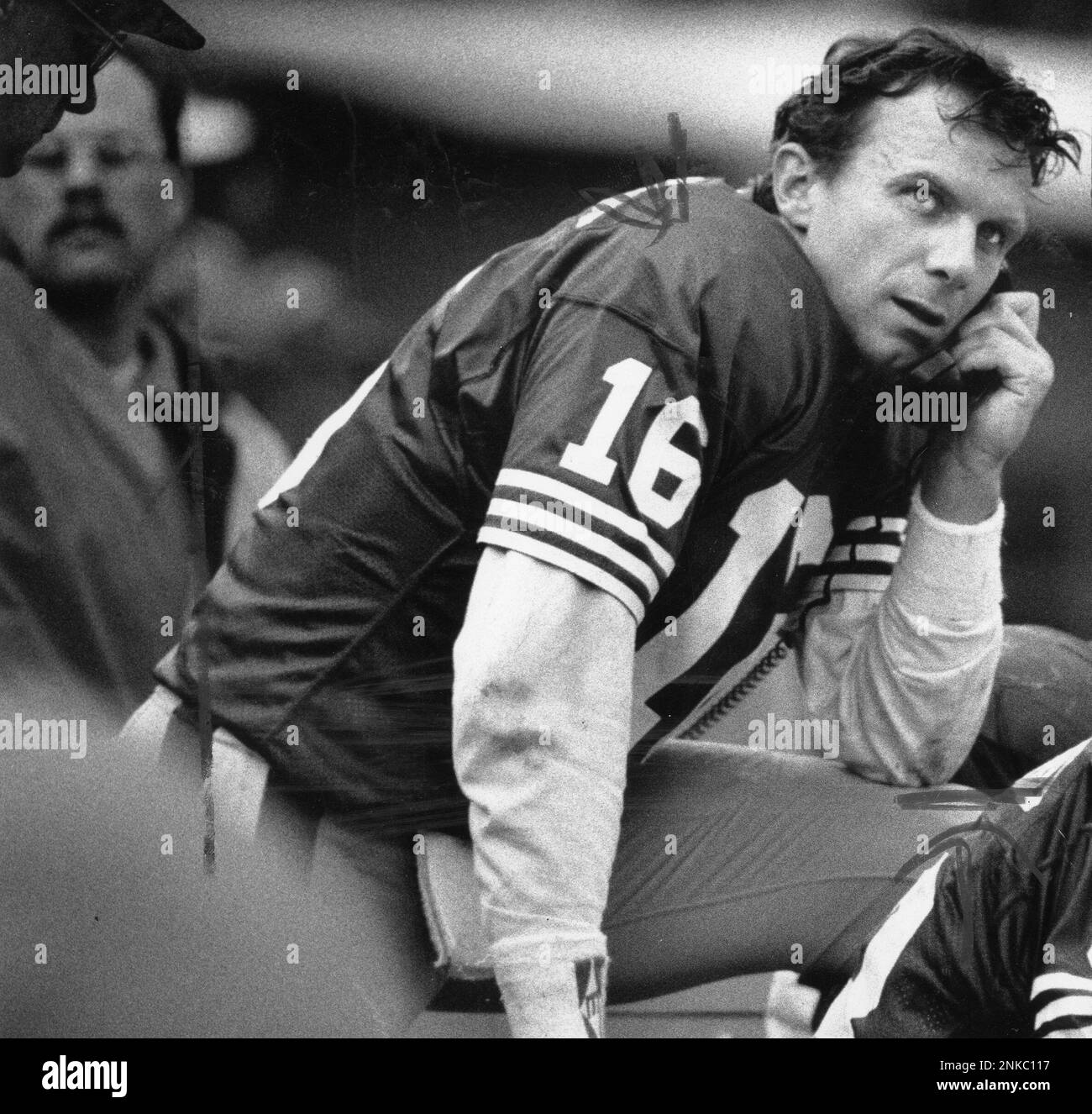 Quarterback Joe Montana talks to coaches on the phone on the