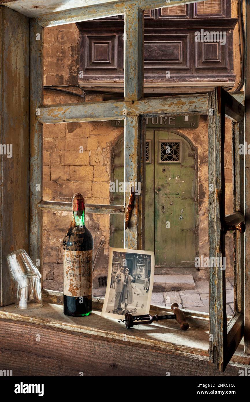 Farmhouse parlour with wine bottle, corkscrew, glasses and photograph