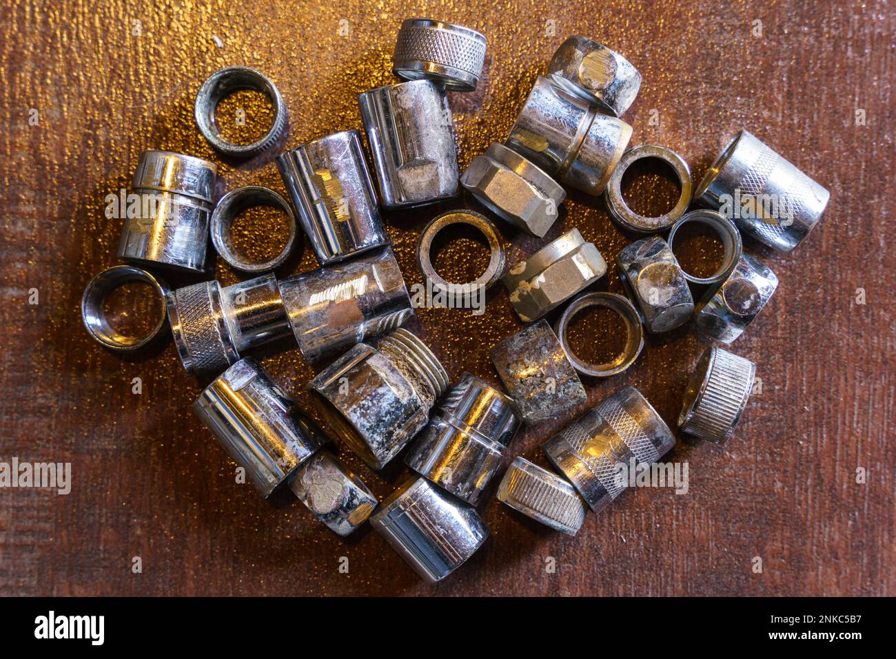 Old brass nuts and fittings for plumbing use recycling. Recycling of non-ferrous scrap Stock Photo