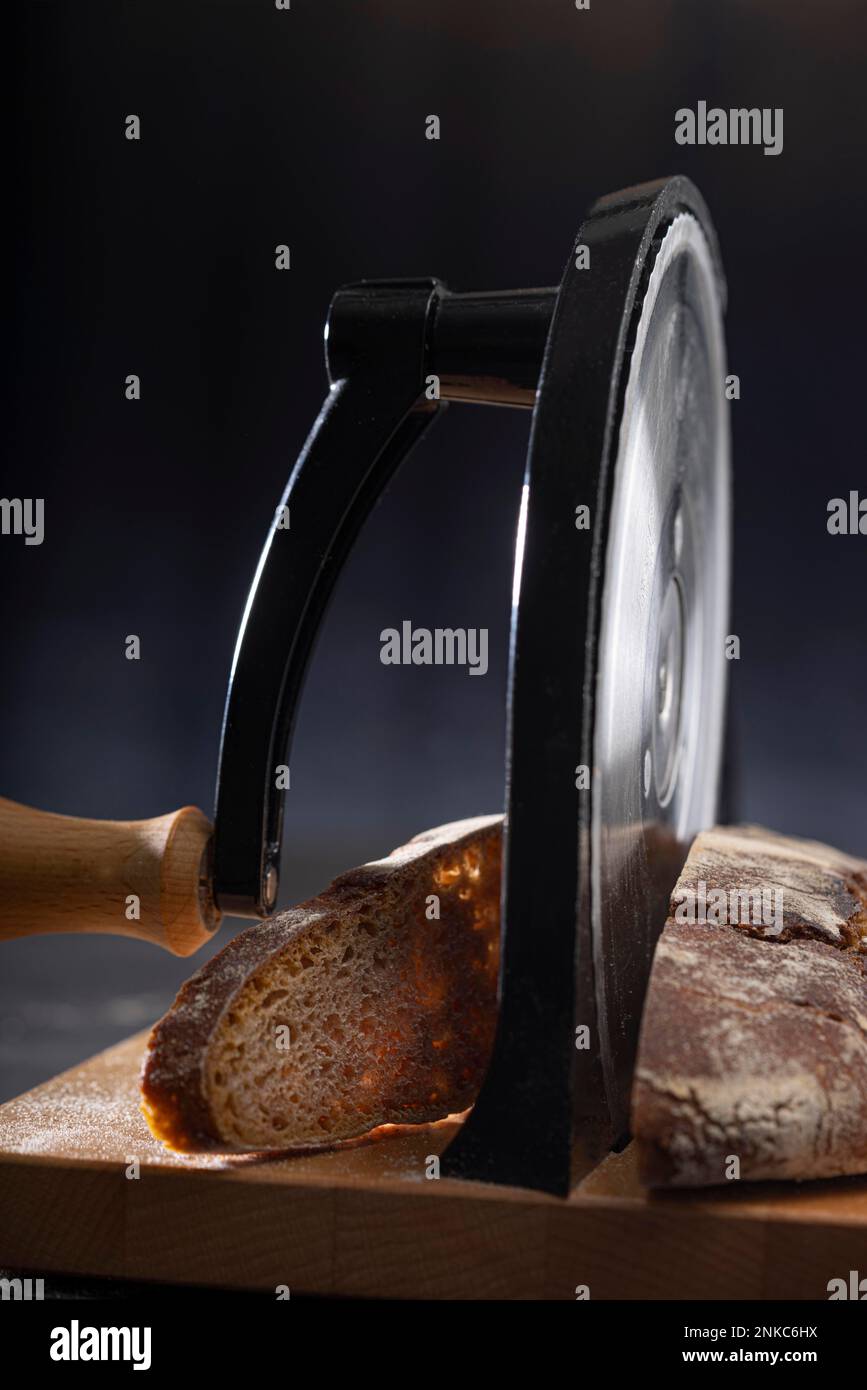 https://c8.alamy.com/comp/2NKC6HX/mixed-bread-with-hand-operated-bread-slicer-2NKC6HX.jpg