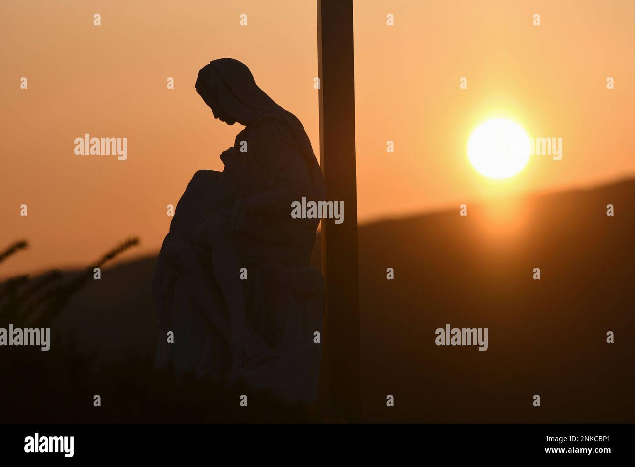 The Pieta statue is seen as the sun rises during St. Patrick Roman