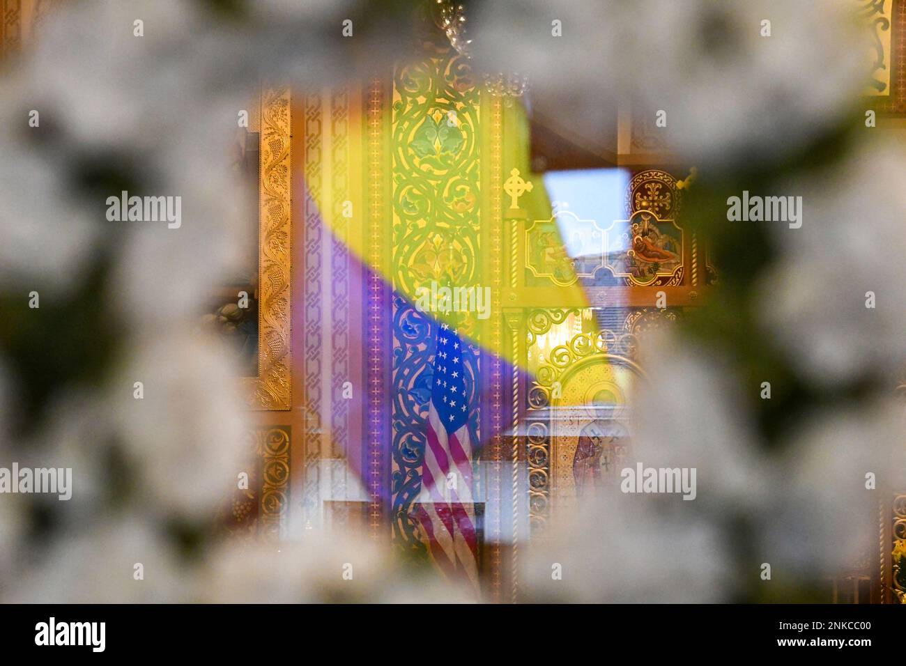 A Ukrainian flag is seen reflected in the vestibule doors looking