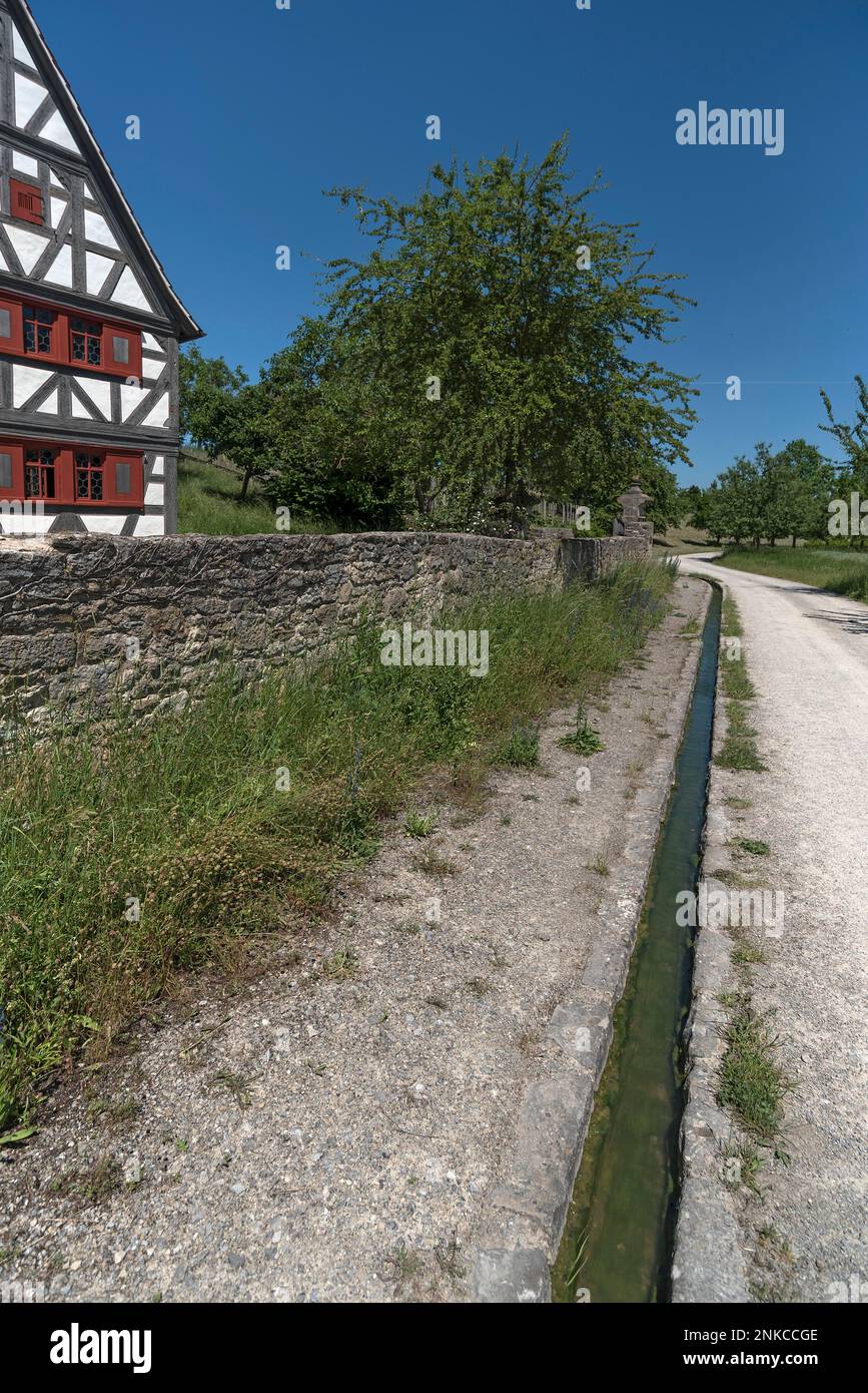 Formerly common water gutters along the roadside, on the left a winegrowers house built in 1668, Franconian Open Air Museum, Bad Windsheim, Middle Stock Photo