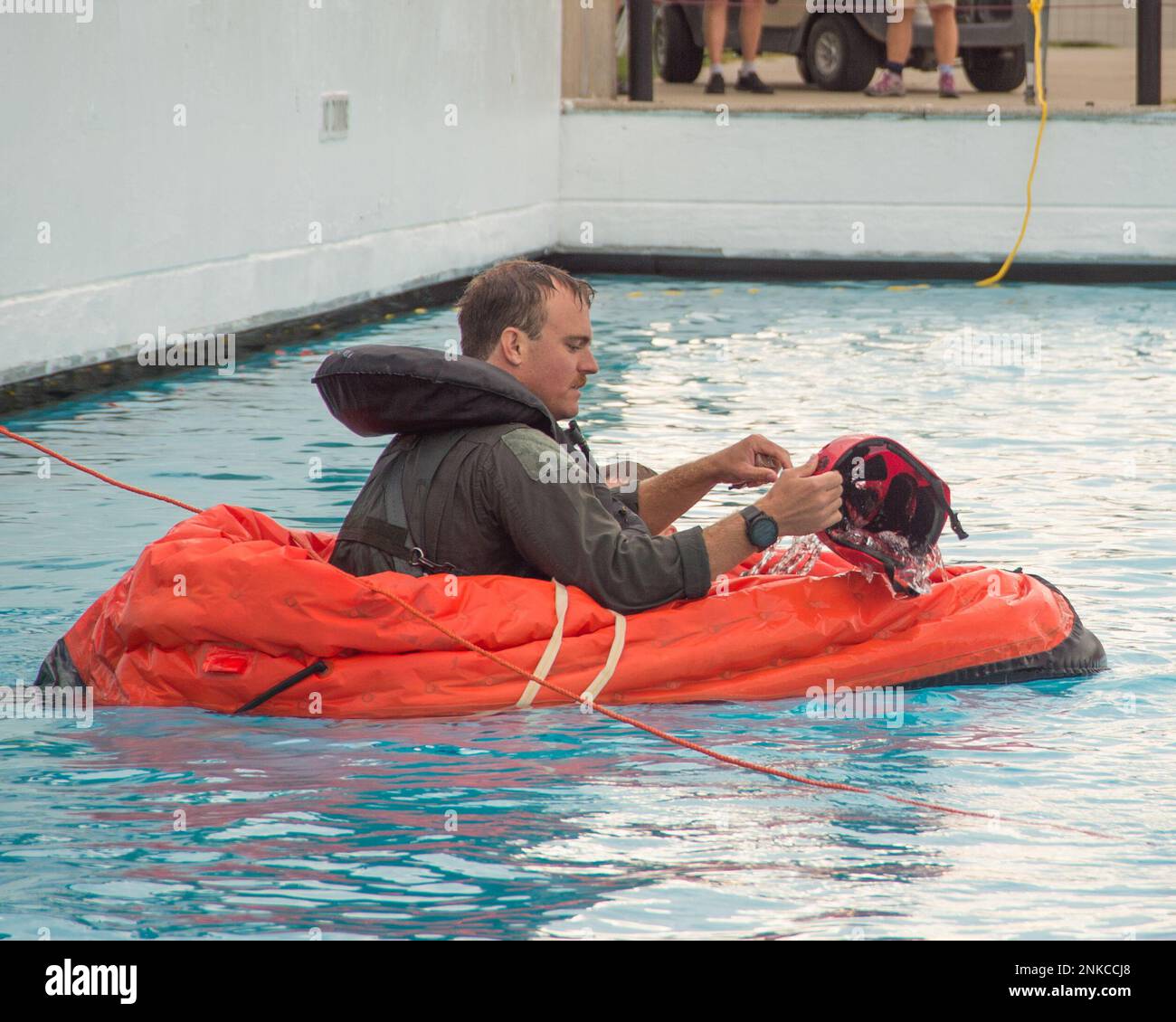 An A-10 Thunderbolt II pilot, 107th Fighter Squadron, Selfridge Air National Guard Base, Michigan, practices removing water from his life raft during water survival training at a local water park on August 13, 2022. Part of a routine skill certification, the survival, evasion, resistance and escape training gave KC-135 Stratotanker aircrew and A-10 Thunderbolt II pilots practice on how to survive if their planes crash over a large body of water. Stock Photo