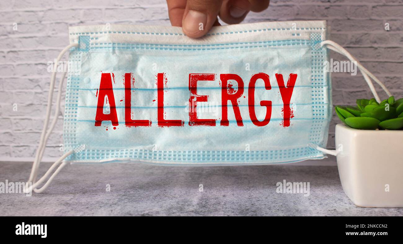 Allergy word written on wood block. Allergy text on cement table for