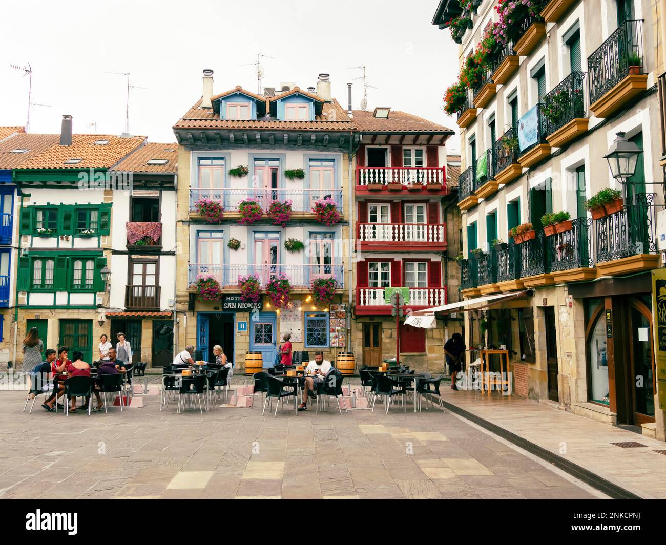 People sitting in the market place of Hondarribia, Basque Country, Spain Stock Photo