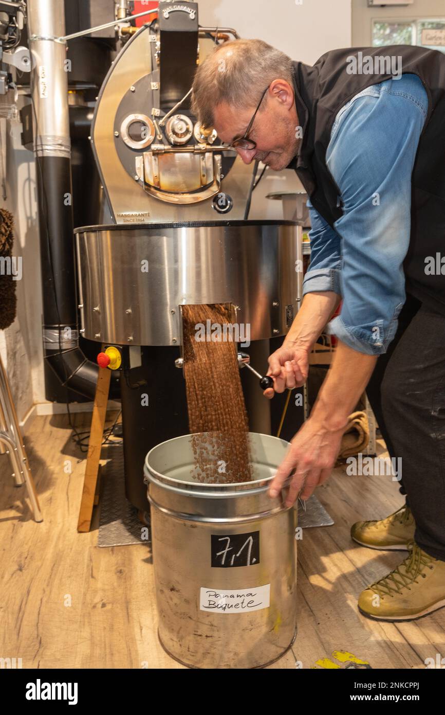 Roasted coffee is filled into buckets, Kaffeeroesterei Maassen ...