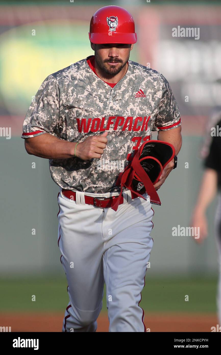 RALEIGH, NC - APRIL 14: NC State Wolfpack assistant coach Brett Austin runs  towards the coaches box during the college baseball game between Boston  College Eagles and the North Carolina State Wolfpack