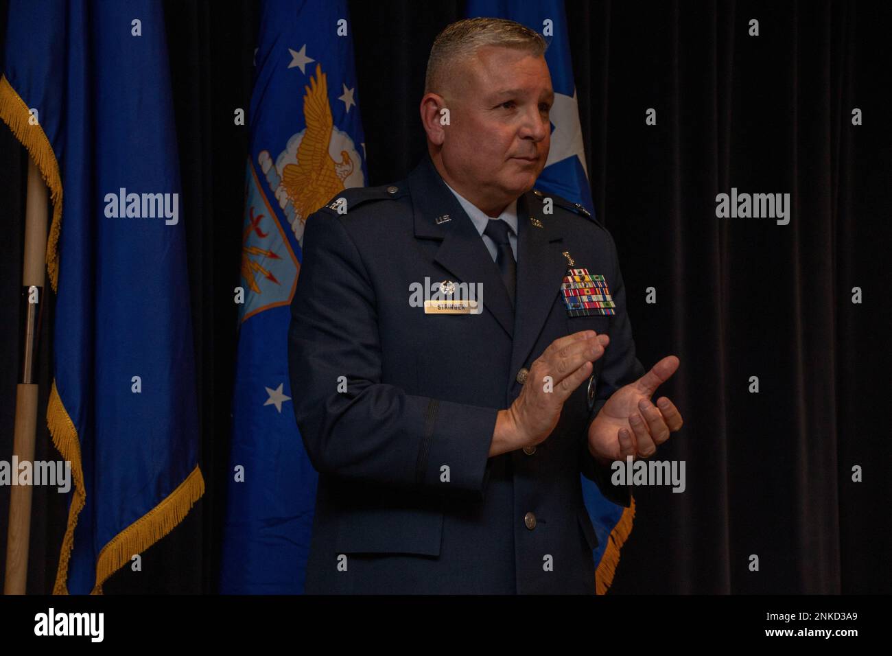 Col. Eric Stringer, the 152nd Medical Group commander, applauds during