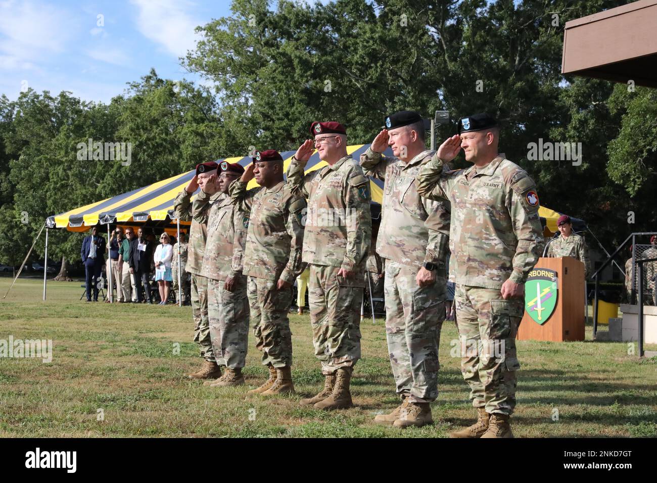 The official party at the U. S. Army Civil Affairs and Psychological Operations Command (AIRBORNE) joint Change of Command, Change of Responsibility, Retirement Ceremony salute during the presentation of the colors on the main parade field, Ft. Bragg, NC., August 13, 2022. Stock Photo