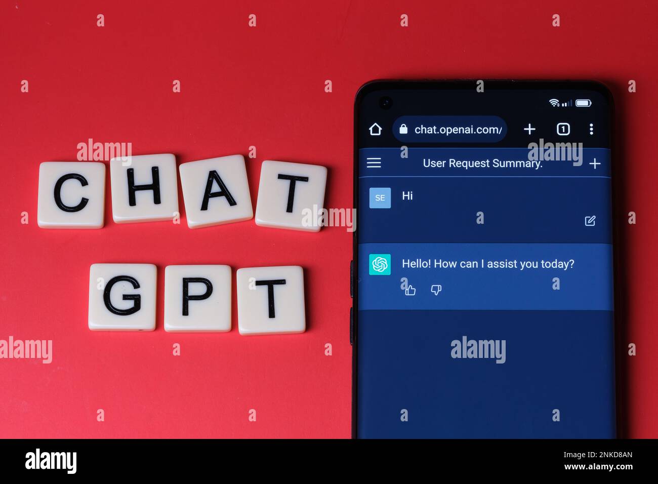 ChatGPT chat bot screen seen on the smartphone and letters CHAT GPT next to it. Stafford, United Kingdom, February 23, 2023 Stock Photo