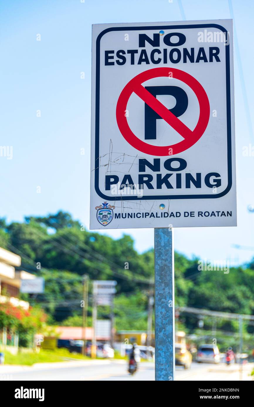 A sign in Spanish that says No Parking, Roatan, Honduras. Stock Photo