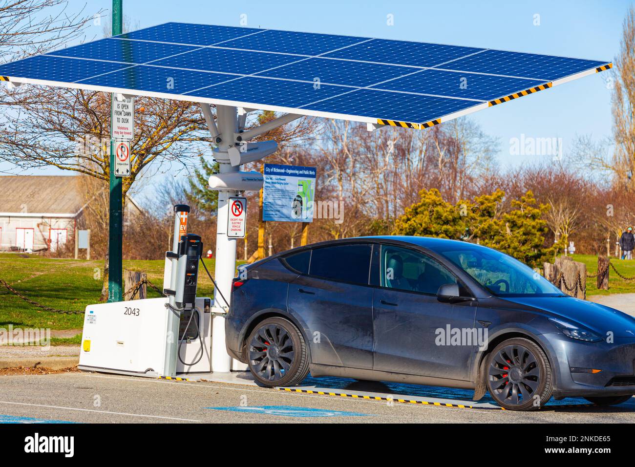 An electric car recharging at a solar powered electrical station in Steveston British Columbia Stock Photo