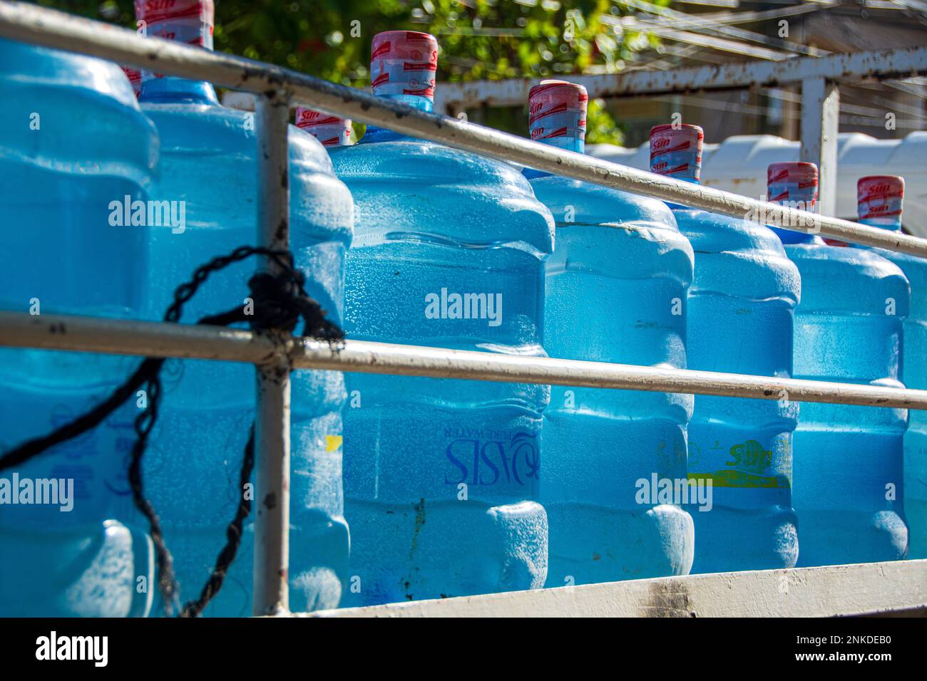 A truck full of giant water bottles to be delivered to local residents, Roatan, Honduras. Stock Photo