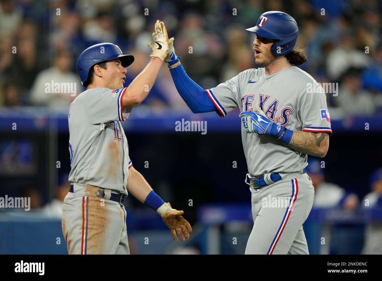 Texas Rangers catcher Jonah Heim, right, is congratulated by teammate