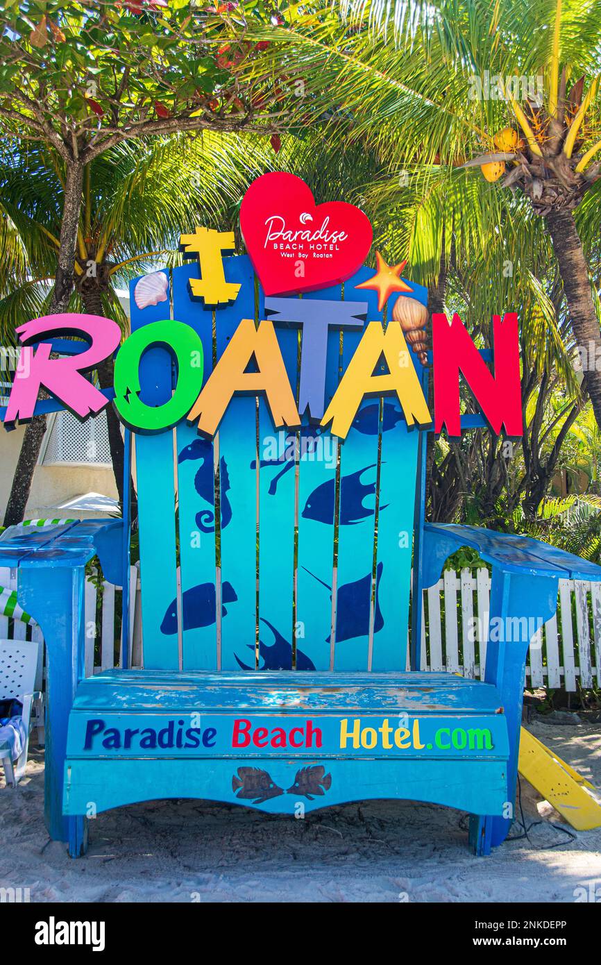 A giant chair with a sign attached saying 'I love Roatan,' Roatan, Honduras. Stock Photo