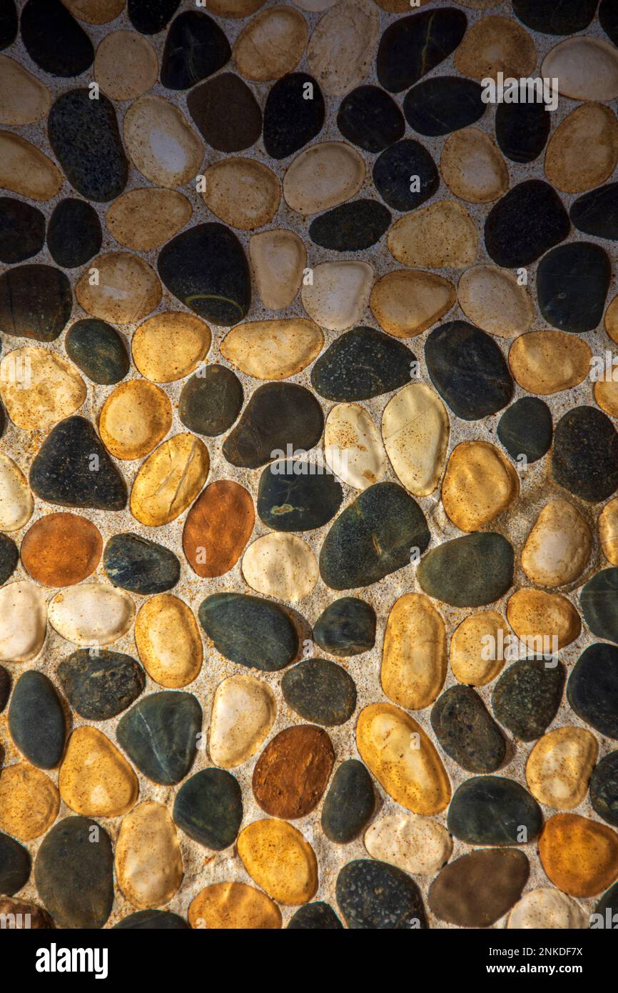 Rock mosaic design on the wall of a home, Roatan, Honduras. Stock Photo