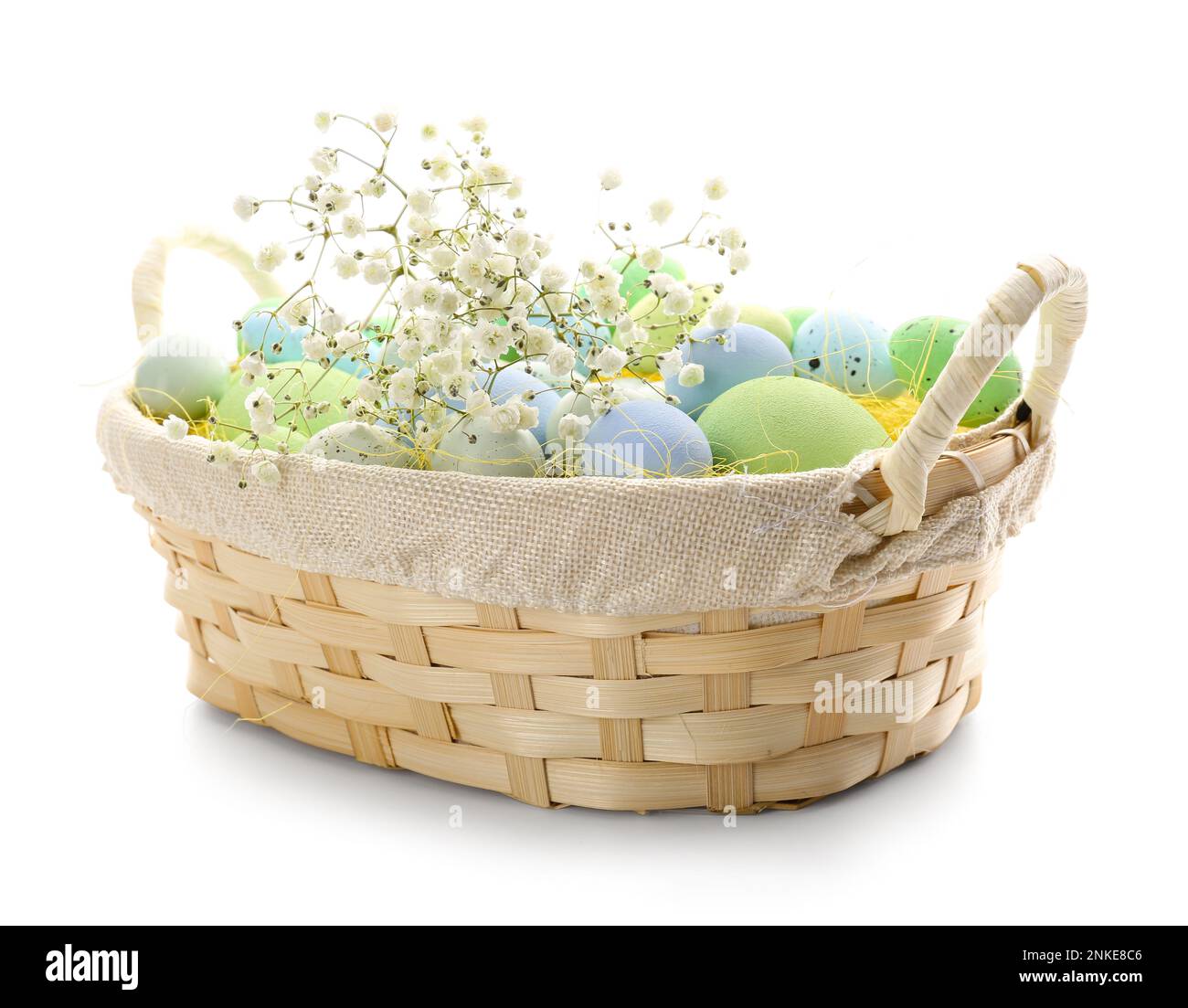 Basket with painted Easter eggs and gypsophila flowers on white ...