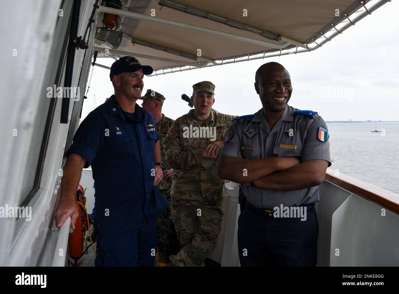 U.S. Coast Guard Cmdr. Andrew Pate, left, commanding officer of USCGC Mohawk (WMEC 913), meets with Côte d’Ivoire Gendarmerie General Bassante Badara Aly, right, on the bridge of the ship in Abidjan, Côte d’Ivoire, Aug. 13, 2022. Mohawk is on a scheduled deployment in the U.S. Naval Forces Africa area of operations, employed by U.S. Sixth Fleet to defend U.S., allied, and partner interests. Stock Photo