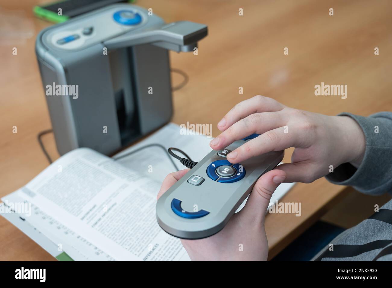 A visually impaired man uses a scanning and reading machine Stock Photo