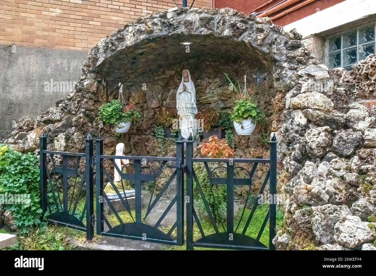 Grotto of Saint Bernadette seeing the vision of Our Lady of Lourdes at the Basilica of St. Stanislaus Catholic Church in Winona, Minnesota USA. Stock Photo
