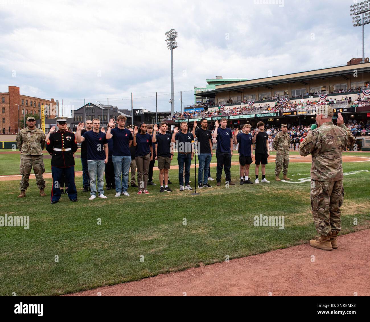 Col. Christopher Meeker, 88th Air Base Wing and Wright-Patterson Air Force Base commander, gives the oath of office to a group of Airmen and Marines during a Dayton Dragons baseball game Aug. 13, 2022 at Day Air Ballpark, Dayton, Ohio. Stock Photo