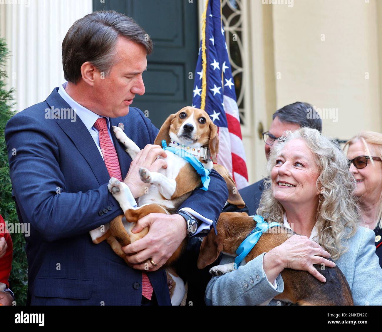 Gov. Glenn Youngkin holds Tannis and Brenda Mahoney holds Bella