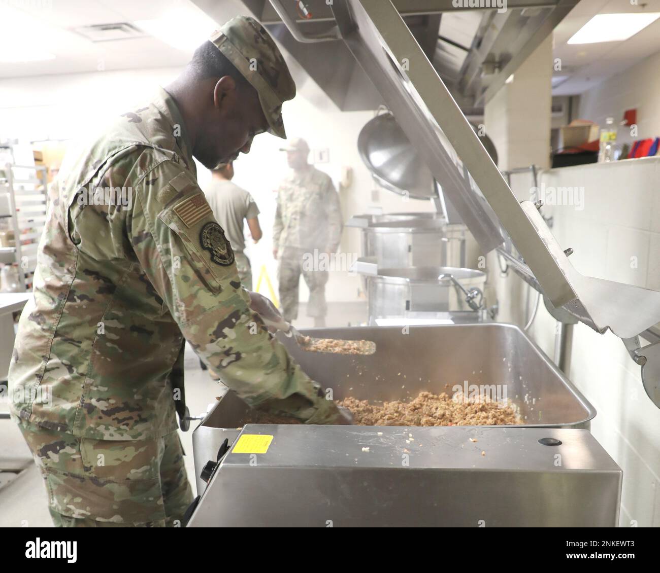 Steam rises from a cooking surface as Senior Airman Nathaniel McKinstry works on meal preparation at Selfridge Air National Guard Base, Michigan, Aug. 14, 2022. McKinstry has been a member of the 127th Force Support Squadron at Selfridge for about three years. The squadron’s Services Flight provides meals, lodging, fitness and other support services to the 1,700 Citizen-Airmen of the 127th Wing at Selfridge. Stock Photo