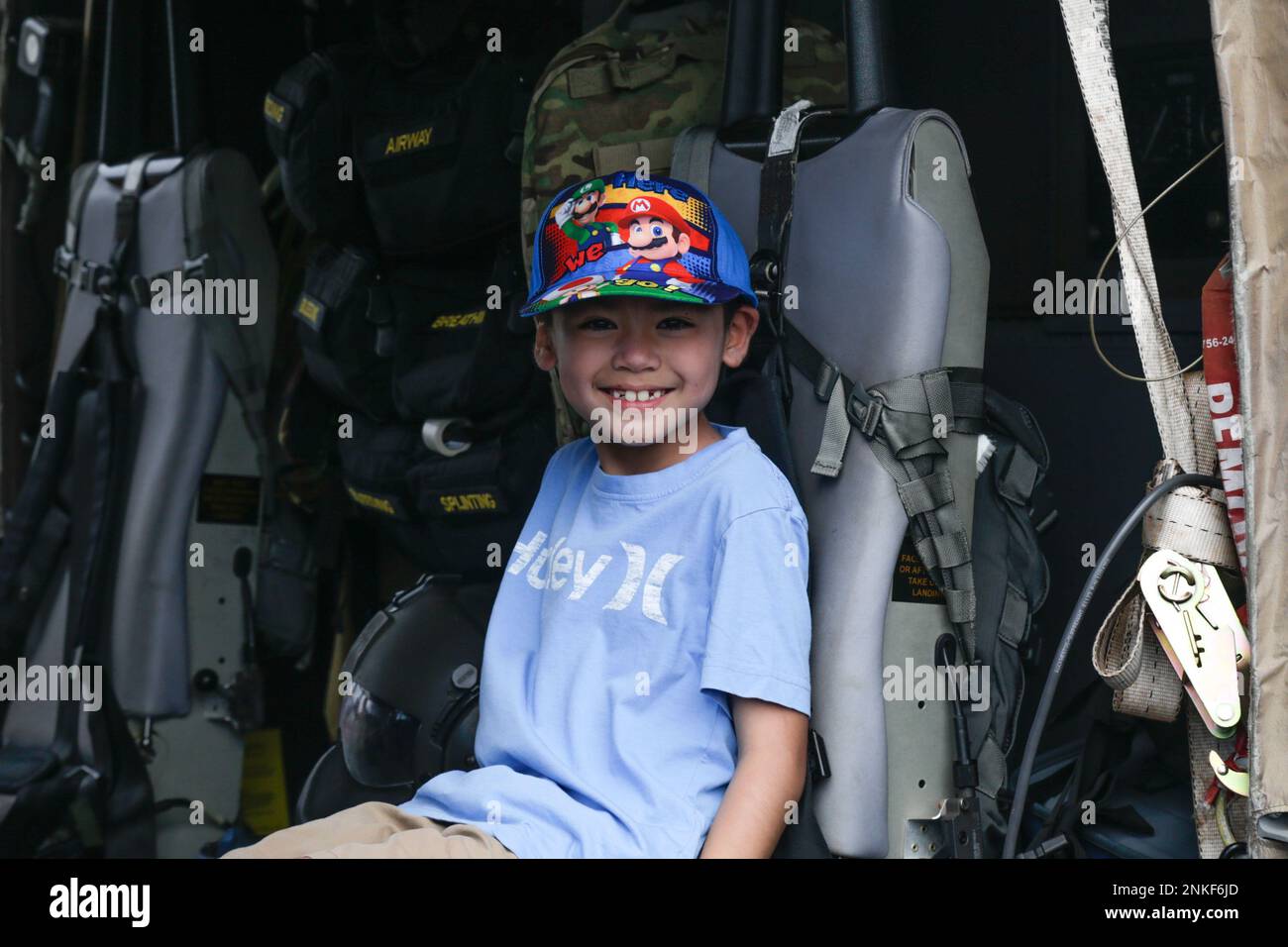 A child tours the inside of a U.S. Army UH-60 Blackhawk as part of the 2022 Kaneohe Bay Air Show, Marine Corps Air Station Kaneohe Bay, Marine Corps Base Hawaii, Aug. 14, 2022. The Kaneohe Bay Air Show, which contained aerial performances, static displays, demonstrations and vendors, was designed to express MCBH’s appreciation to the residents of Hawaii and their continued support of the installation. Stock Photo