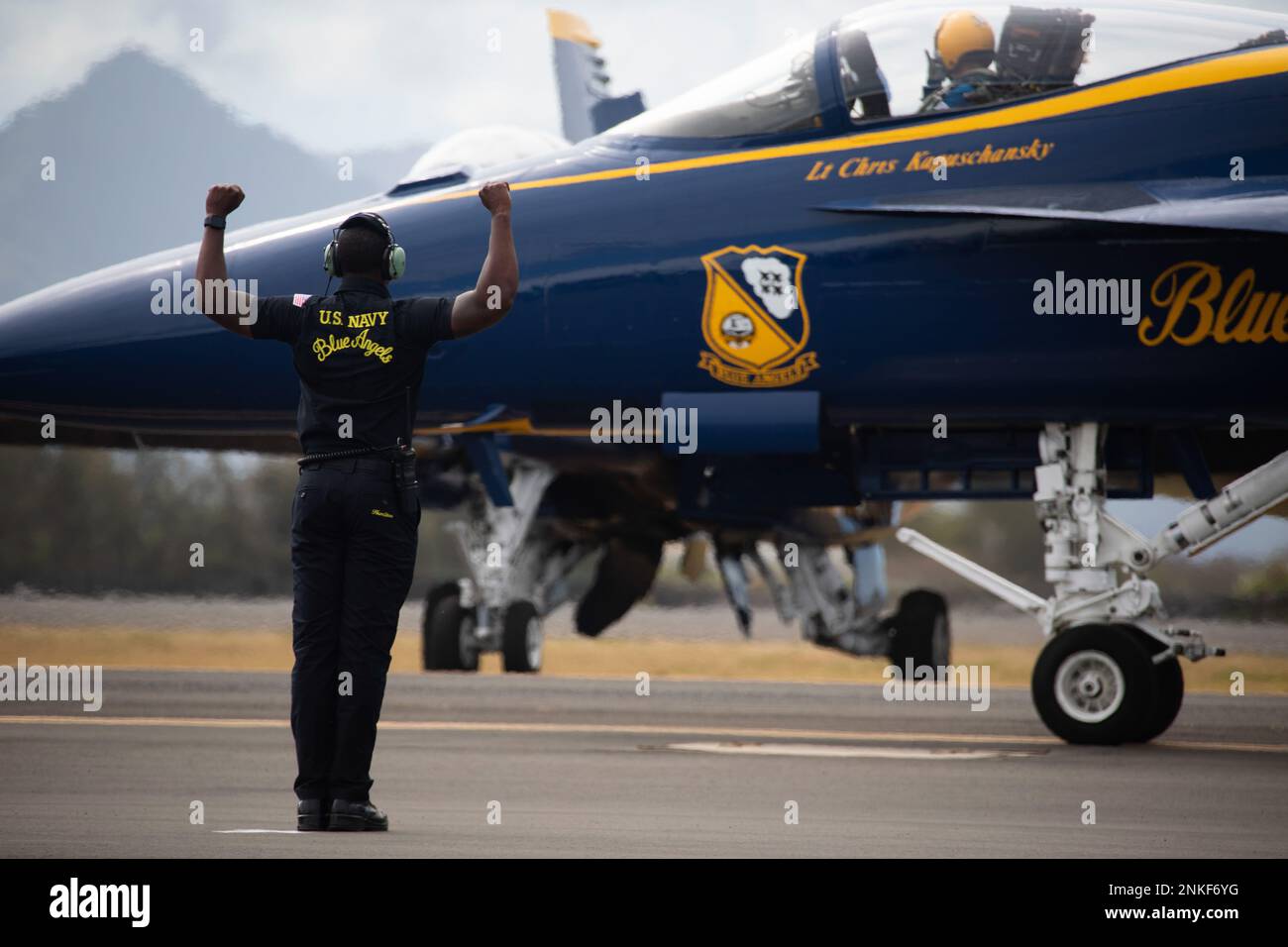 Maintenance crew members with the U.S. Naval Flight Demonstration Squadron, The Blue Angels, prepare to take off as part of the 2022 Kaneohe Bay Air Show, Marine Corps Air Station Kaneohe Bay, Marine Corps Base Hawaii, Aug. 14, 2022. The air show provided an opportunity for MCBH to foster positive relationships with the local community, while providing a unique experience to the public. The Kaneohe Bay Air Show, which contained aerial performances, static displays, demonstrations and vendors, was designed to express MCBH’s appreciation to the residents of Hawaii and their continued support of Stock Photo