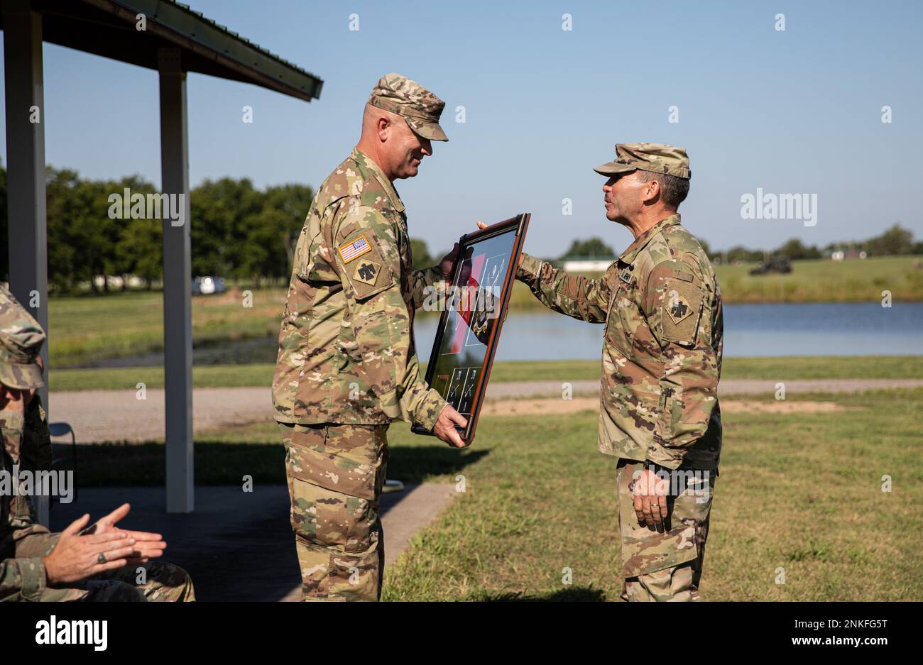 Command Sgt. Maj. Chris Murray presents Col. Colby Wyatt, outgoing commander of the 45th Infantry Brigade Combat Team, Oklahoma National Guard, with the Meritorious Service Medal during a change of command ceremony, Camp Gruber Training Center, Okla., Aug. 14, 2022. Wyatt served as the commander of the 45th IBCT for three years and relinquished command to Col. Andrew Ballenger. (Oklahoma Army National Guard photo by Spc. Danielle Rayon) Stock Photo