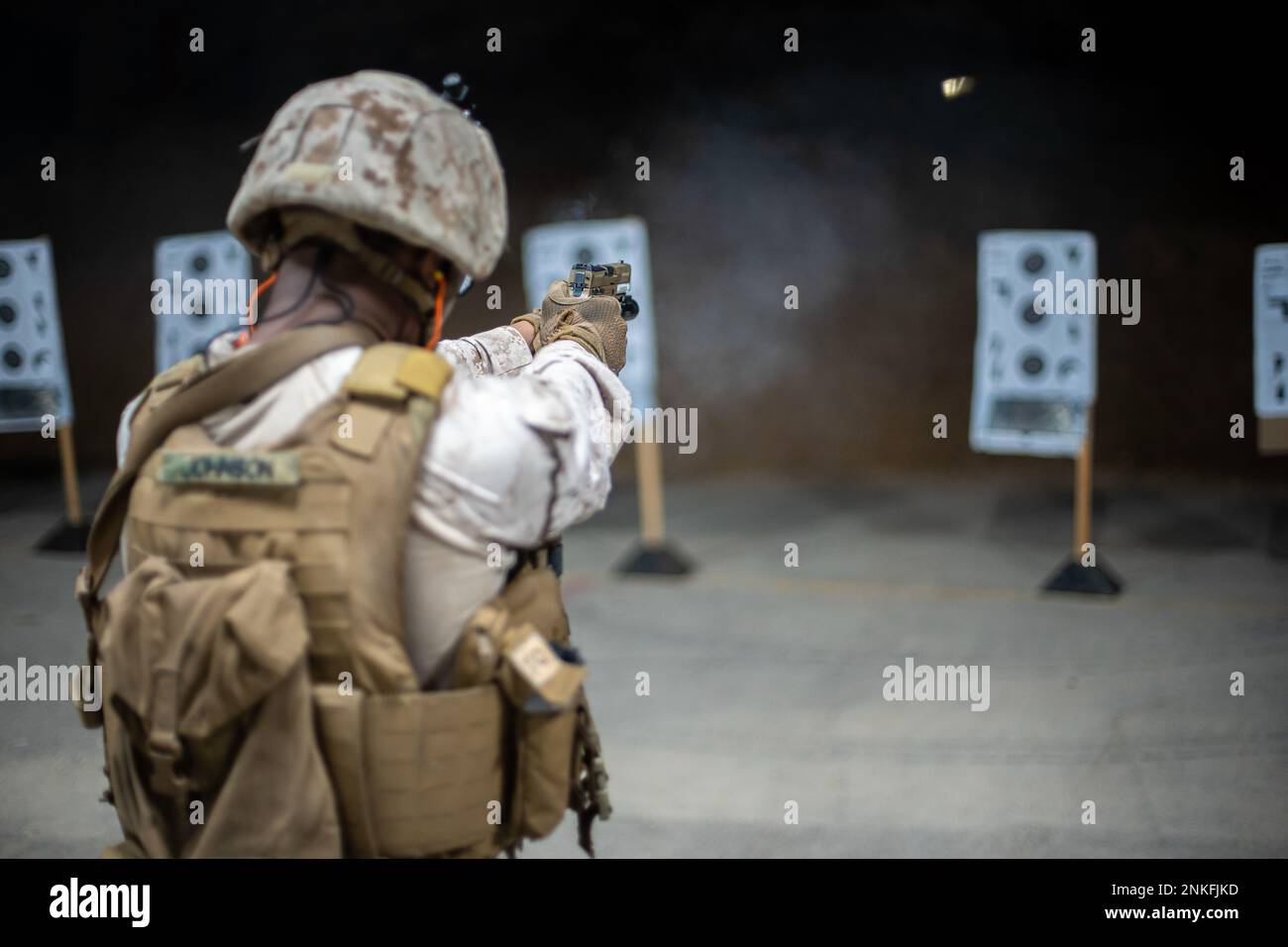 U.S. FIFTH FLEET AREA OF OPERATIONS (August 14, 2022) – A U.S. Marine assigned to Fleet Anti-Terrorism Security Team Central Command (FASTCENT) fires an M18 pistol during a live-fire drill at a training facility in the U.S. 5th Fleet area of operations, Aug. 14. FASTCENT provides expeditionary antiterrorism and security forces to embassies, consulates and other vital national assets throughout the region. Stock Photo