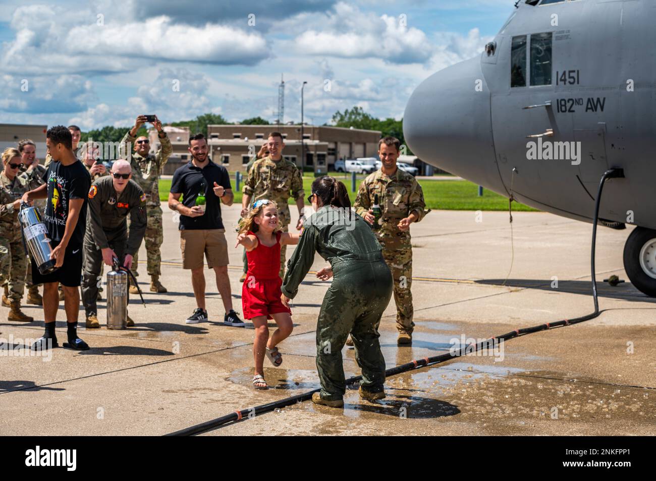 U.S. Air Force Lt. Col. Shannon Wrage, a navigator with the 169th Airlift Squadron, Illinois Air National Guard, greets her daughter after her “fini flight” at the 182nd Airlift Wing in Peoria, Illinois, Aug. 14, 2022. Wrage has 26 years of military service. Stock Photo