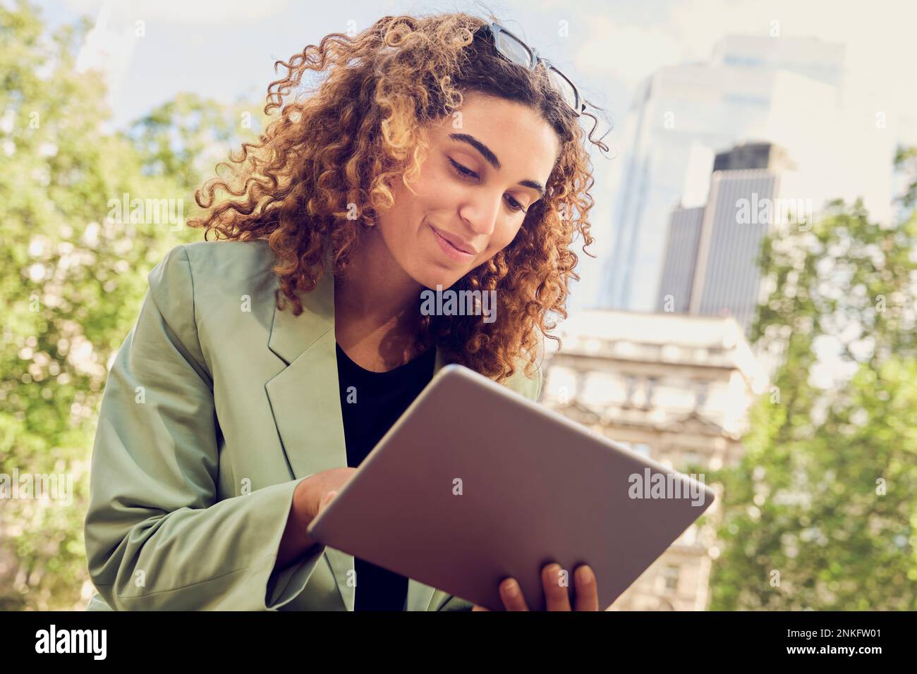 Smiling businesswoman using tablet PC Stock Photo