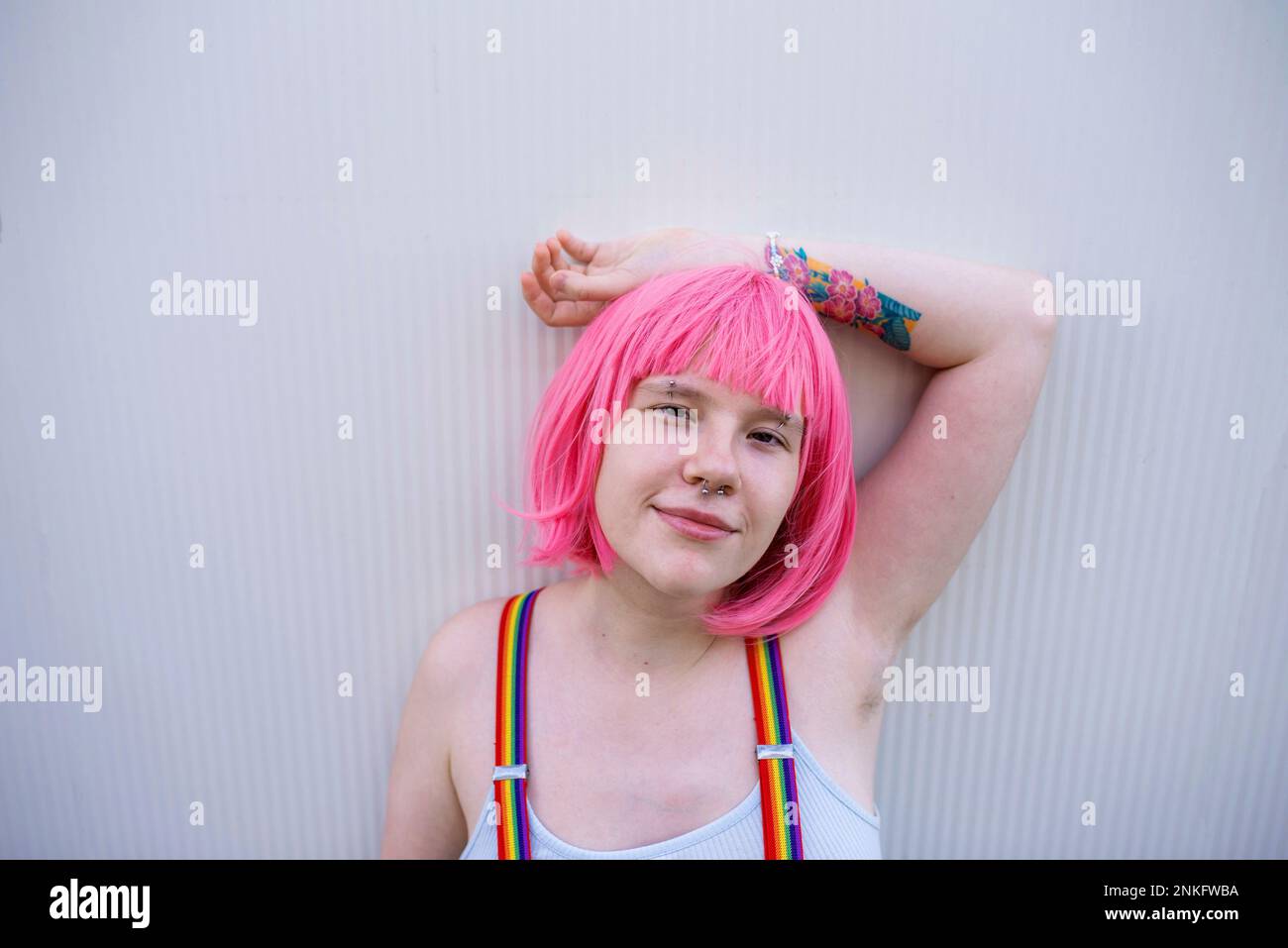 beautiful stylish girl in pink wig holding scissors isolated on pink, Stock image