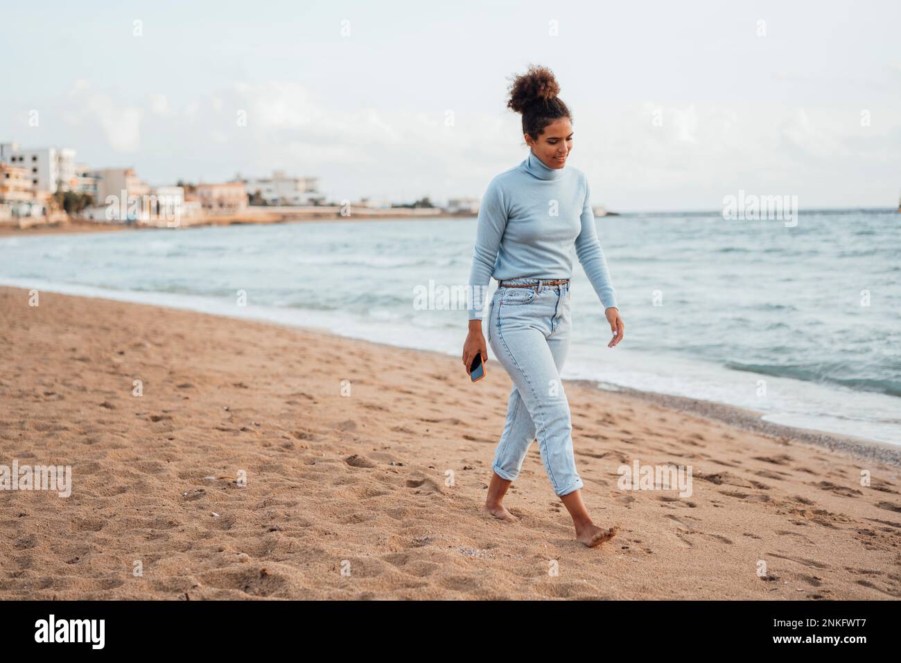 Woman walking sand beach hi-res stock photography and images - Alamy