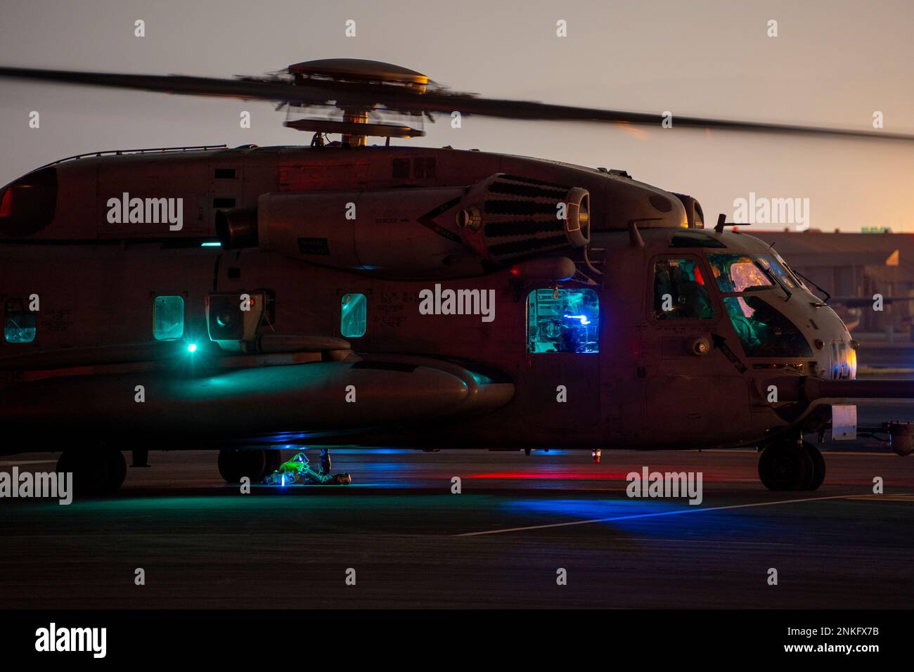 A U.S. Marine Corps CH-53E Super Stallion helicopter with Marine Medium Tiltrotor Squadron 262 (Reinforced), 31st Marine Expeditionary Unit (MEU), sits on the flight line prior to nighttime external lift training at Marine Corps Air Station Iwakuni, Japan, Feb. 19, 2023. This helicopter support team exercise was conducted to certify pilots in sling load operations and improve tactical proficiency. The 31st MEU, the Marine Corps’ only continuously forward-deployed MEU, provides a flexible and lethal force ready to perform a wide range of military operations as the premiere crisis response force Stock Photo