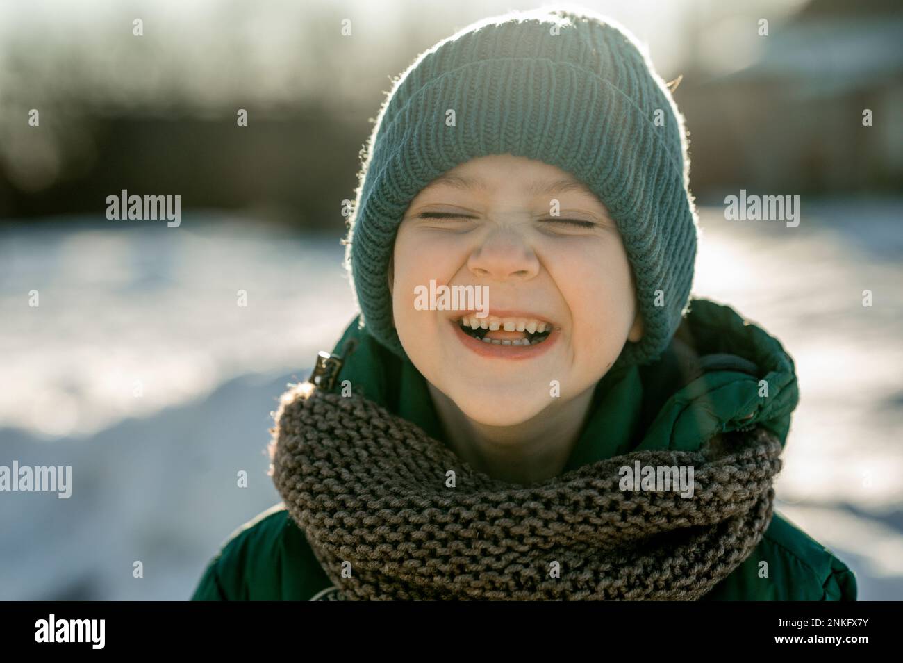 Cheerful boy wearing knit hat in winter Stock Photo