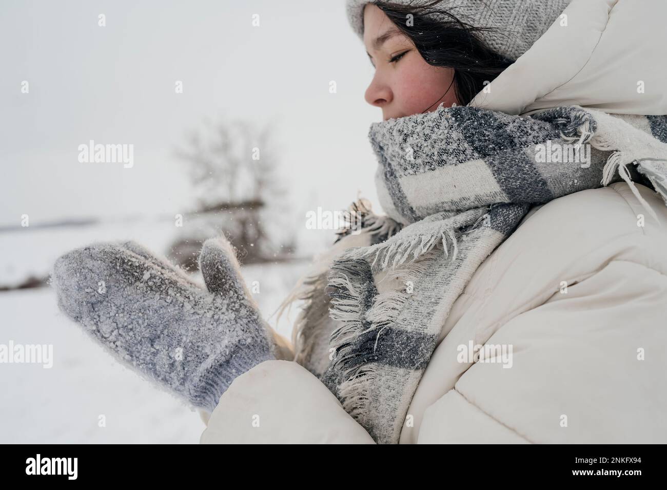 Teenage girl wearing gloves standing in winter Stock Photo Alamy