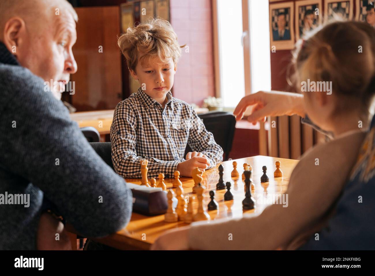 Smiling grandfather having idea about next chess move Stock Photo by  ©Dmyrto_Z 165212578