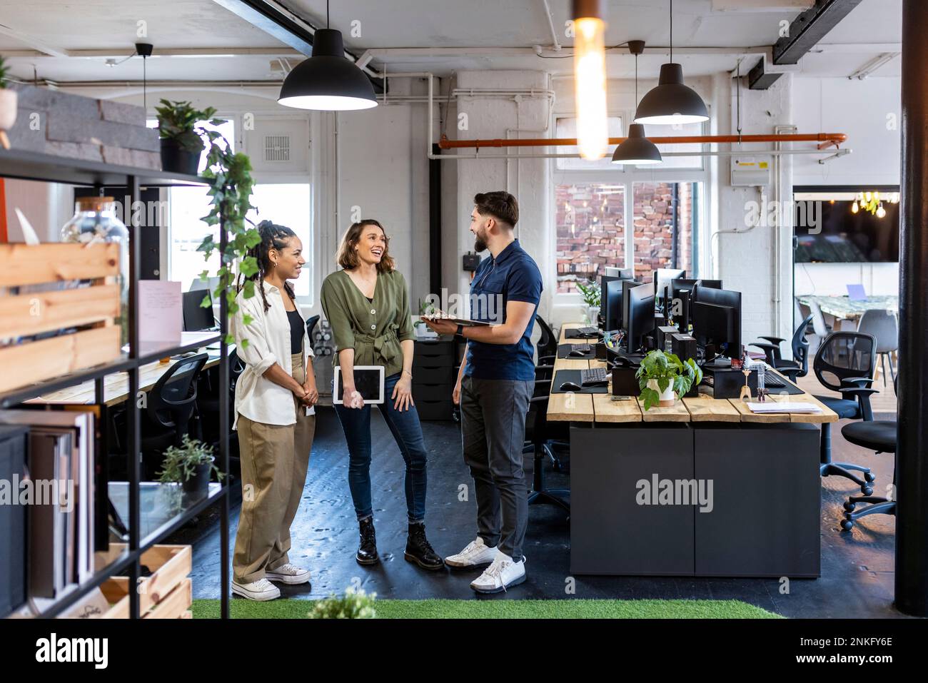 Happy business people standing together in office Stock Photo