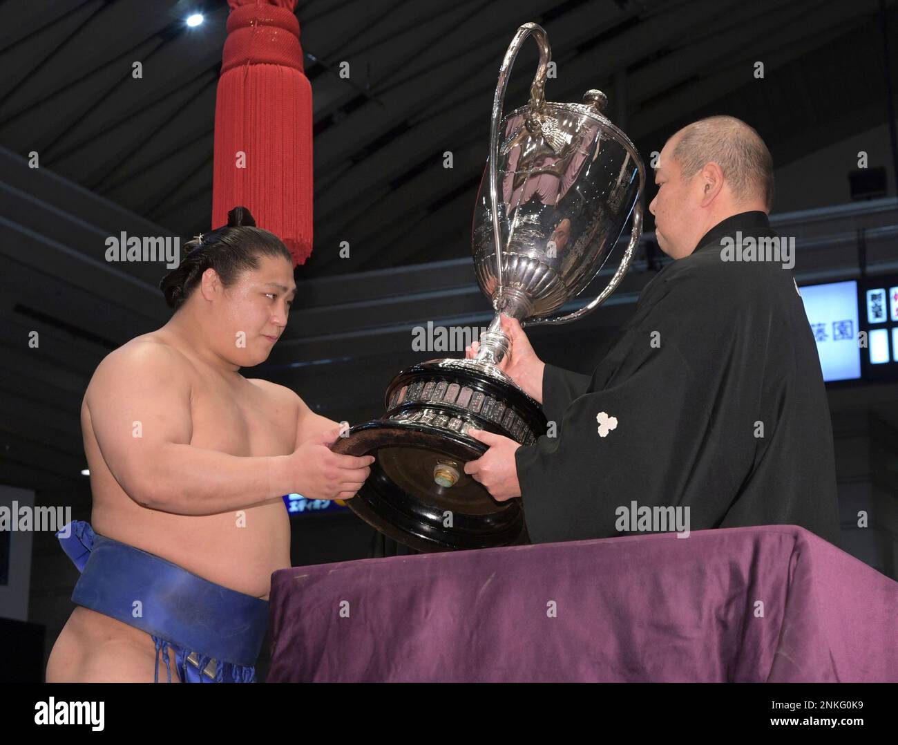 Sekiwake Wakatakakage receives the trophy after winning the Osaka Sumo