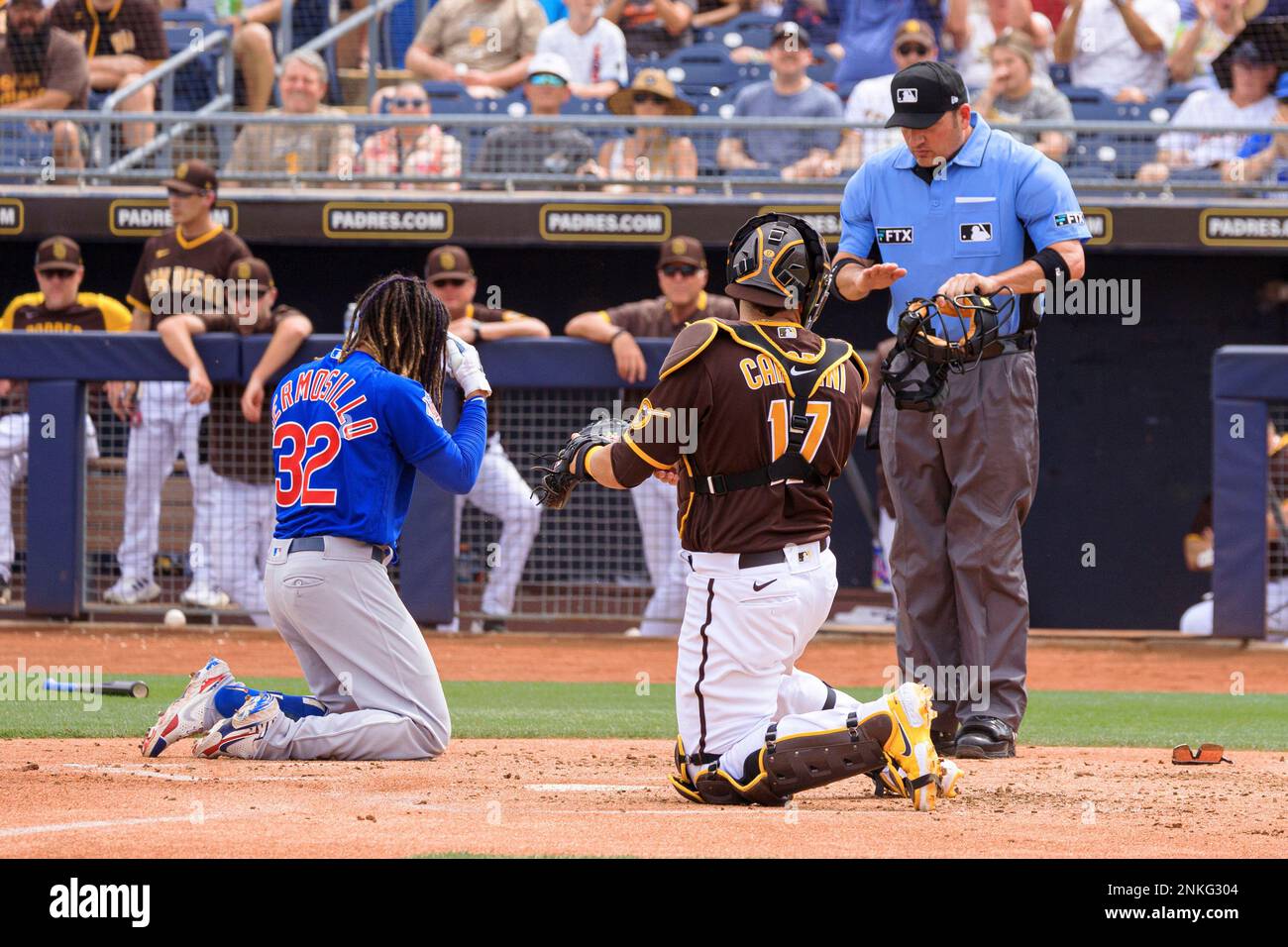 PEORIA, AZ - MARCH 26: Chicago Cubs outfielder Michael Hermosillo (32)  slides into home plate during the MLB Spring Training baseball game between  the Chicago Cubs and the San Diego Padres on